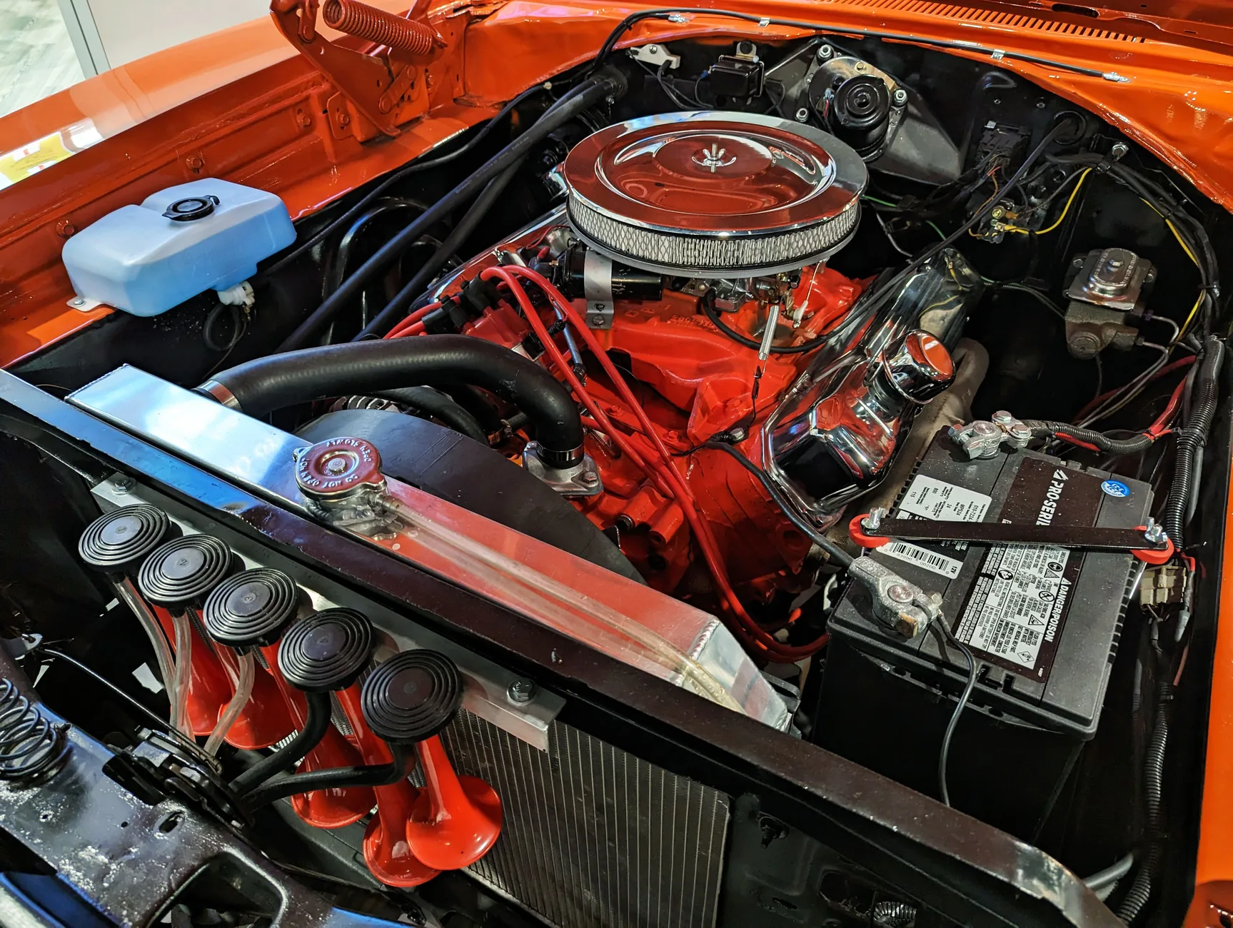 Automotive engine bay showing radiator, cooling and engine components