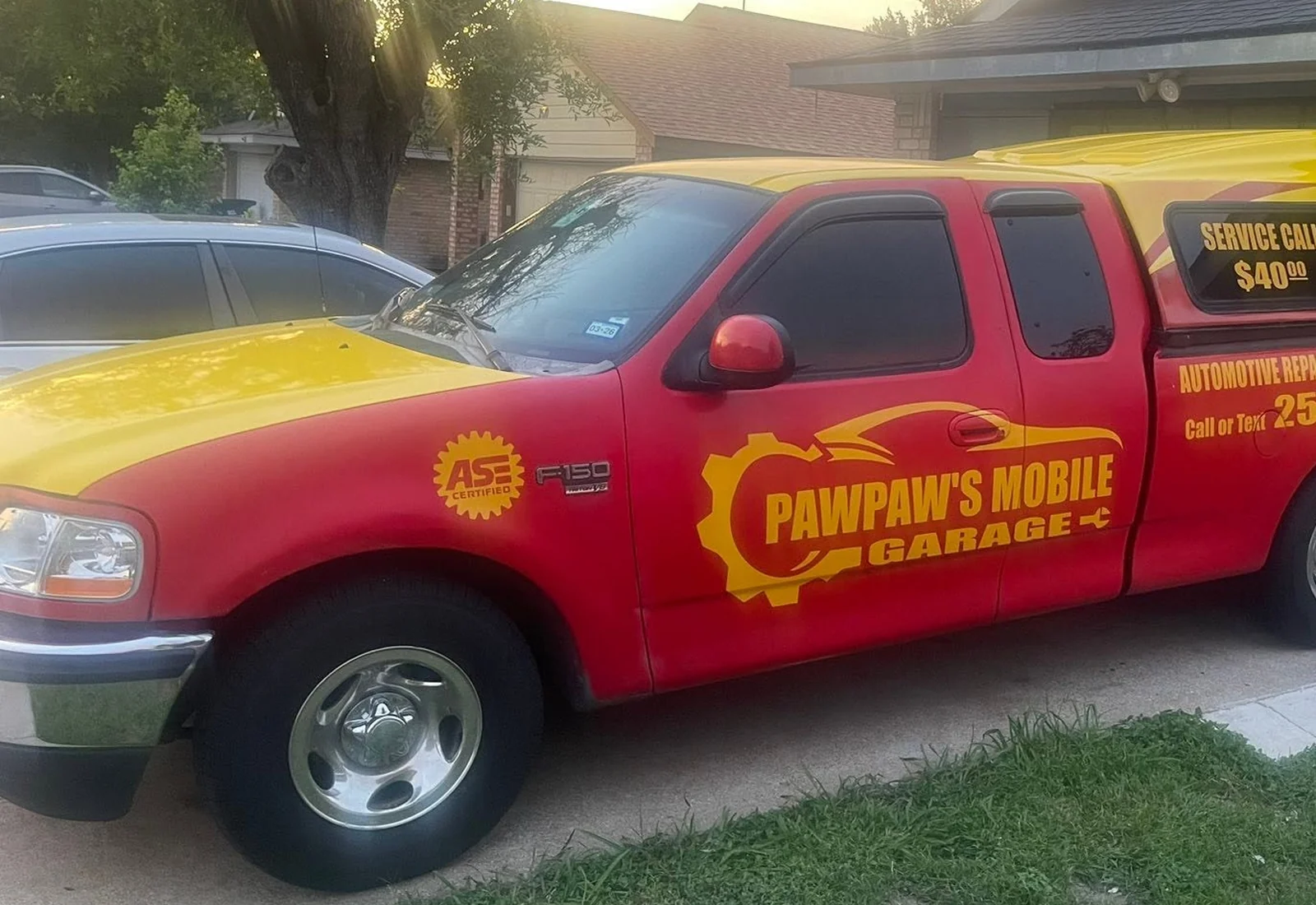 PawPaw\'s Mobile Garage red and yellow mobile mechanic service truck