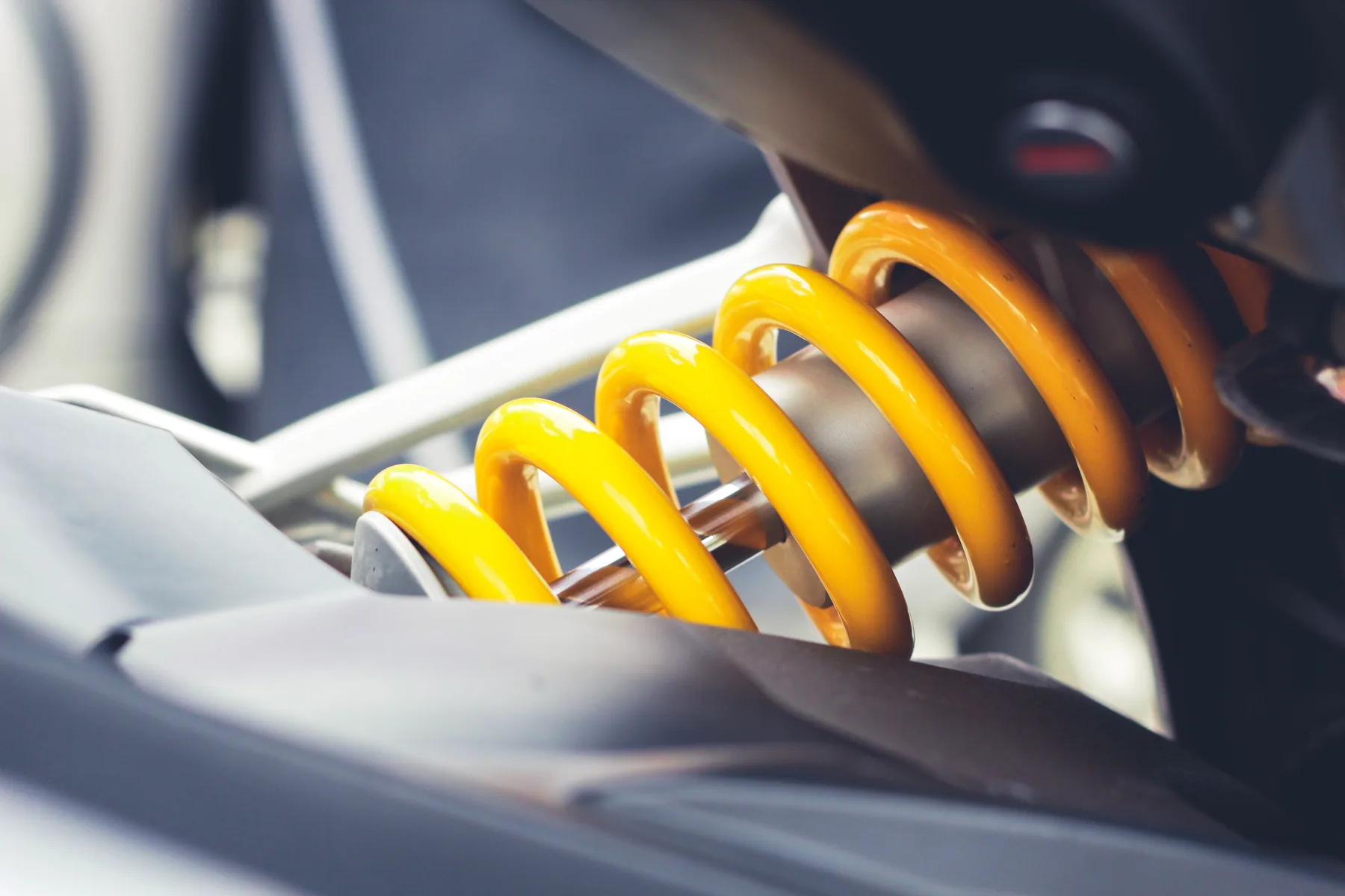Close-up of an automotive suspension coil spring and shock assembly